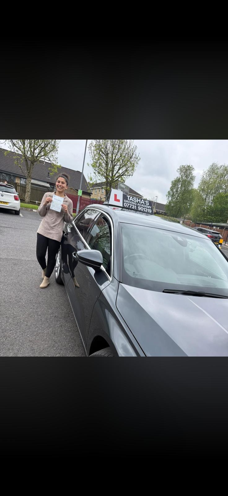 Happy learner celebrating after passing their UK driving test